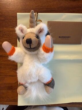 Burberry White Plush Unicorn Key Charm with Orange trim, it’s new.